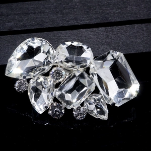 Macro detail of crystal bridal shoe clips featuring multi-shape rhinestone clusters