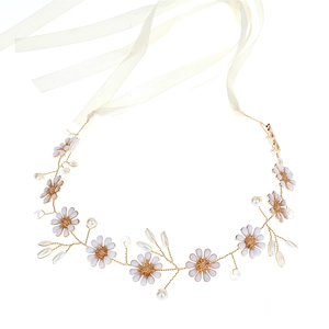 Detail of bridal headband with white enamel flowers, pearls, and golden wire weave