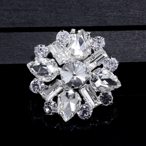 Macro shot of sparkling crystal wedding shoe clip with a symmetrical floral gem arrangement