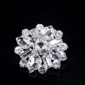 Detailed macro view of symmetrical crystal shoe clip with sparkling rhinestone snowflakes