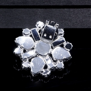 Macro view of the silver metal shoe clip back with sturdy flip-top clasp mechanism
