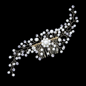 Close-up of handmade bridal hair comb with gold wires, white pearls and clear crystals