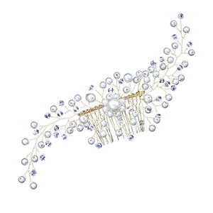 Detailed macro view of handmade bridal hair comb with pearls and crystals on gold wire