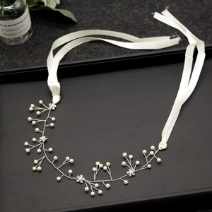 Cerchietto da sposa argento con perle e strass fatti a mano su un vassoio da esposizione