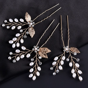 Detailed view of three baroque gold leaf hair pins with pearls and crystals for brides