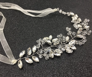 Detailed view of handmade bridal hair vine with crystal beads and white ribbon ties