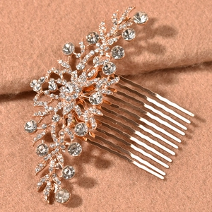 Detail of rose gold bridal hair comb with sparkling white rhinestones and floral design