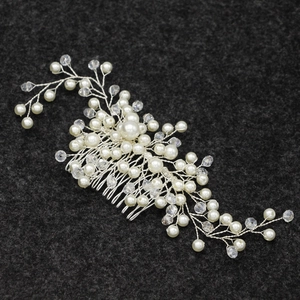 Detail of silver bridal hair comb with handmade pearls and crystal flower clusters