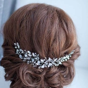 Elegant silver bridal hair vine with sparkling crystals on a sophisticated updo hairstyle