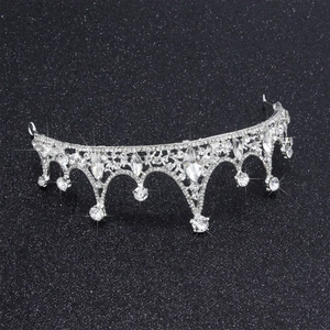 Sparkling silver crystal crown with rhinestone drops on shimmering black background