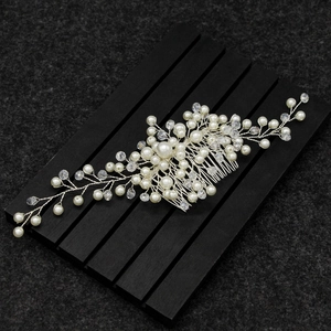 Detailed view of handmade silver bridal hair comb with elegant pearls and crystal beads