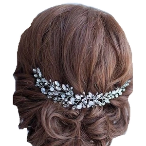 Detailed view of a silver bridal vine hairpiece with crystals worn on a dark brown bun
