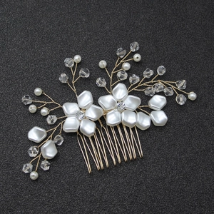 Detail of white pearl flower bridal hair comb with gold wire and sparkling crystals