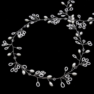 Macro detail of handmade freshwater pearl bridal hair vine with crystals and silver wire