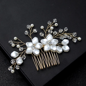 Close-up of gold wire bridal hair comb with white pearls and crystal flower accents