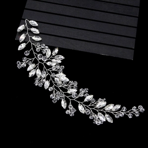 Exquisite silver bridal hair vine with marquise and round crystals on a black wood base