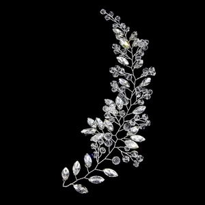 Close-up of bridal crystal hair vine with silver wire and marquise stones on black background