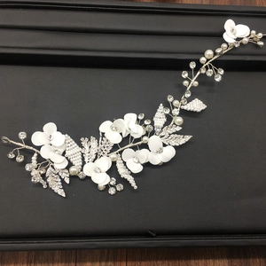 Elegant bridal hair vine with white fabric petals, pearls and crystals on silver wire