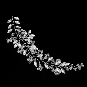 Detailed macro view of silver bridal hair vine with crystal rhinestones on black background
