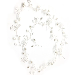 Close-up of handmade bridal hair vine with freshwater pearls and silver wire weave