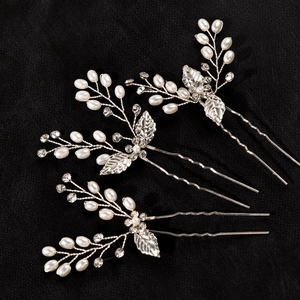 Elegant bridal hair pins set with silver leaves, white pearls and sparkling crystals
