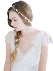 Detail of handmade pearl and crystal bridal hair vine woven with golden alloy wire