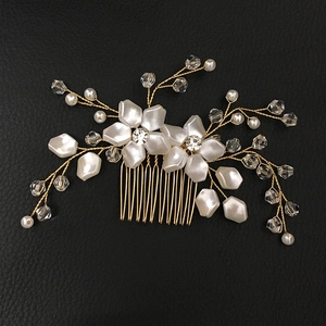 Detail of handcrafted gold wire bridal hair comb with white pearls and crystals