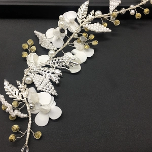 Detail of handmade bridal hair vine with fabric flowers, silver leaves and pearl beads