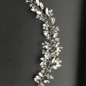Macro detail of hand-woven bridal hair vine with silver wire and sparkling crystals