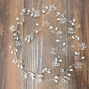 Detailed macro view of handmade bridal hair vine with freshwater pearls and crystals