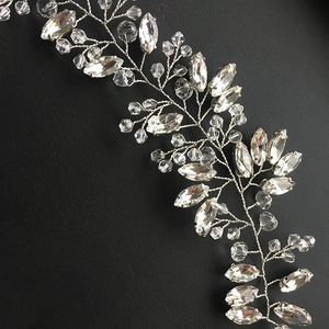 Close-up of silver crystal bridal hair vine with marquise stones on black leather