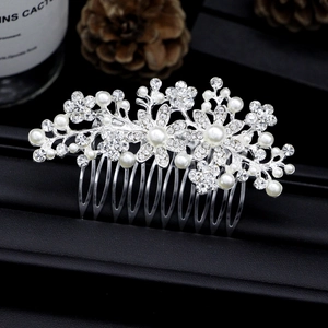 Detailed close-up of bridal hair comb with pearls and rhinestones on a silver base