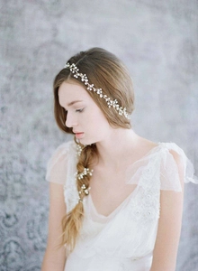 Detail of handcrafted freshwater pearl bridal hair vine woven into a bride's hairstyle