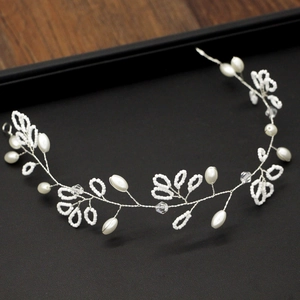Detail of handmade bridal hairband featuring white pearls and crystals on silver wire