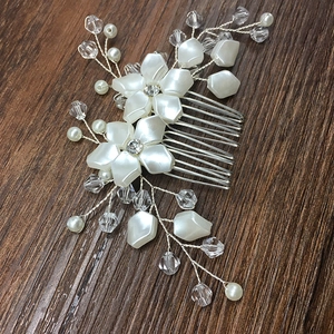 Detail of silver bridal hair comb with white pearl flowers and crystal beads