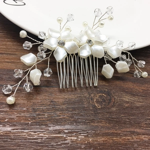 Detail showing bridal hair comb with white pearls, resin petals and silver alloy teeth