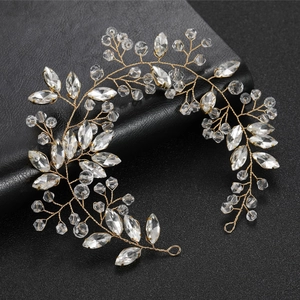 Detail of handmade gold bridal hair vine with crystal leaves and secure end loops
