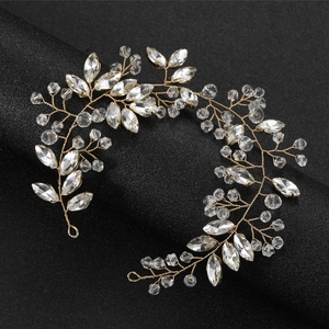 Close-up of bridal crystal hair vine with golden wire and sparkling marquise rhinestones