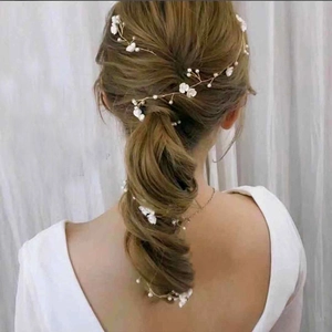 Detail of a 1m bridal hair vine with white shell flowers and pearls on gold wire