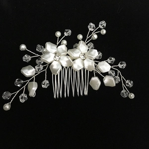 Detail of handmade bridal hair comb with white flowers, pearls, and crystal beads