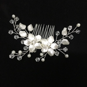 Detailed view of handmade silver bridal hair comb with white pearls and clear crystals