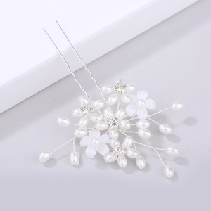Detailed close-up of handmade bridal hair pin with pearls and rhinestone flower