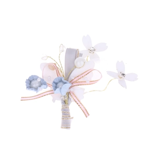 Detailed view of handmade light blue satin flower boutonniere with pearls and crystals