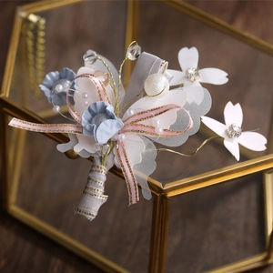 Exquisite handmade wedding boutonniere with chiffon flowers and pearls on jewelry box