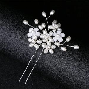Close-up of pearl and crystal flower bridal hair pin with silver twisted wire design