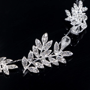 Détail macro d'une coiffe de mariée argentée avec feuilles ornées de strass brillants