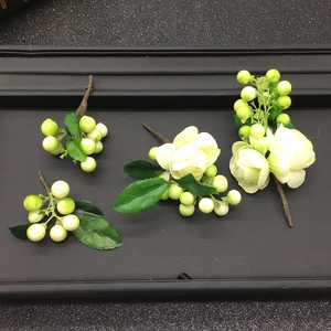 Detail view of 4-piece set floral accessories with white flowers and green berries