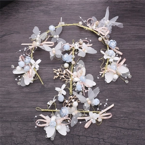 Detail of bridal hair accessory set with blue chiffon butterflies and pearls