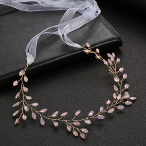 Elegant gold bridal headband with pink crystal leaf details and white organza ribbon