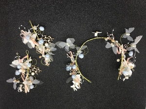Detailed close-up of handmade bridal headband set with blue butterflies and pearls